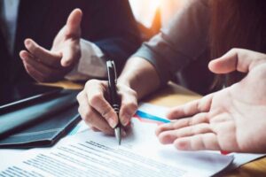 People reviewing and signing legal documents.