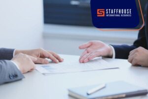 Interview discussion with resume on the table.
