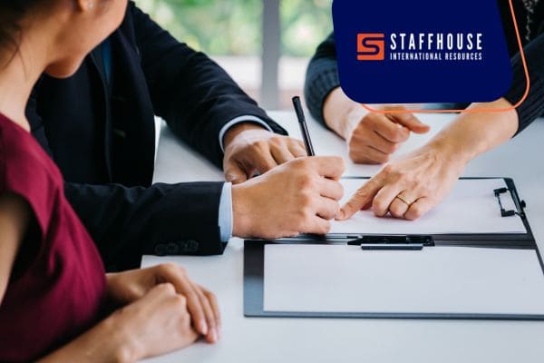 Signing job contract during meeting.